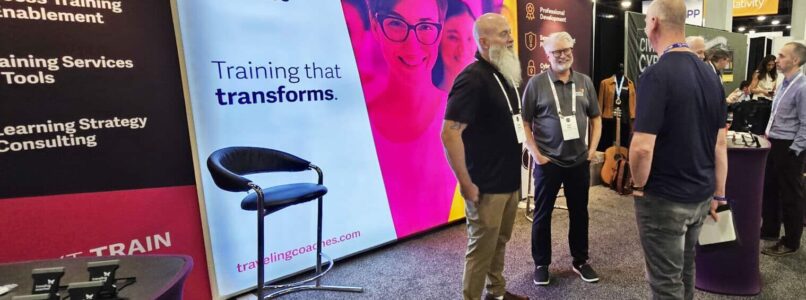 Traveling Coaches booth at ILTACON 2024, Employees talking and discussing programs with clients and interested guests
